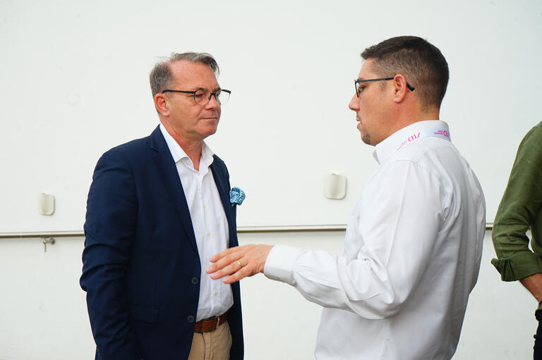 The Consul General discussing with a company representative